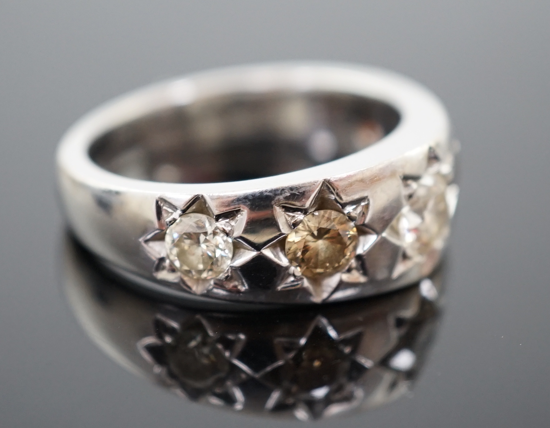 A modern bespoke 18ct white gold and graduated gypsy set five stone coloured diamond set ring